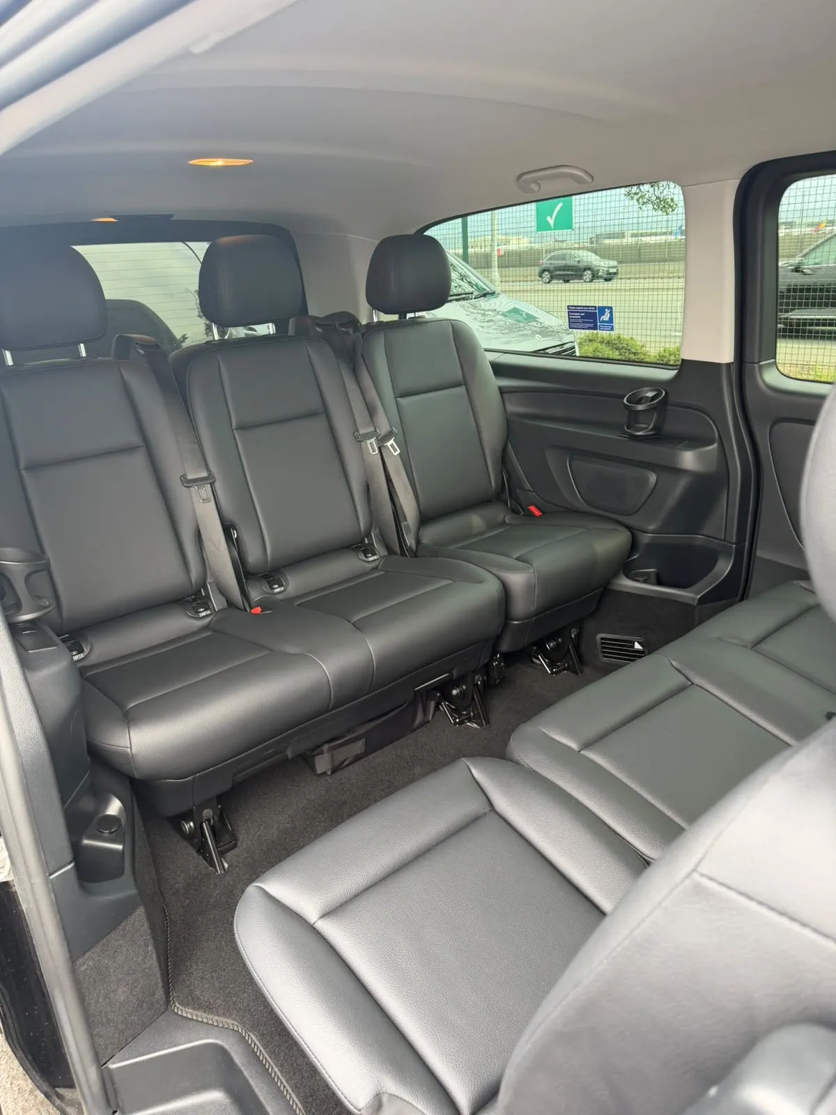 Inside the Mercedes people carrier at the airport, seats ready for passengers